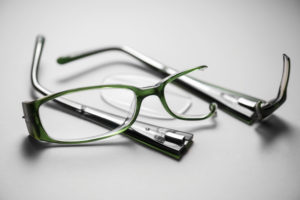 Broken plastic spectacles on a white background with strong shad VisualEyes based out of Ankeny Iowa, IA 50023