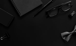 Black notebook and cellphone on desk office VisualEyes based out of Ankeny Iowa, IA 50023