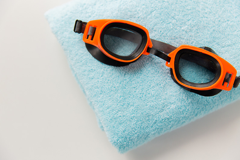 close up of swimming goggles and towel VisualEyes based out of Ankeny Iowa, IA 50023